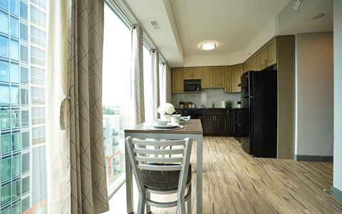 A modern kitchen with a dining table and chairs.