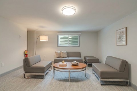 A living room with grey couches and a coffee table.