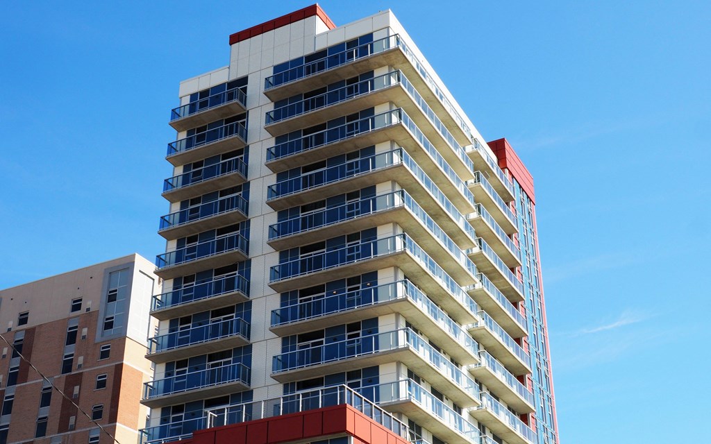 an apartment building against a clear blue sky
