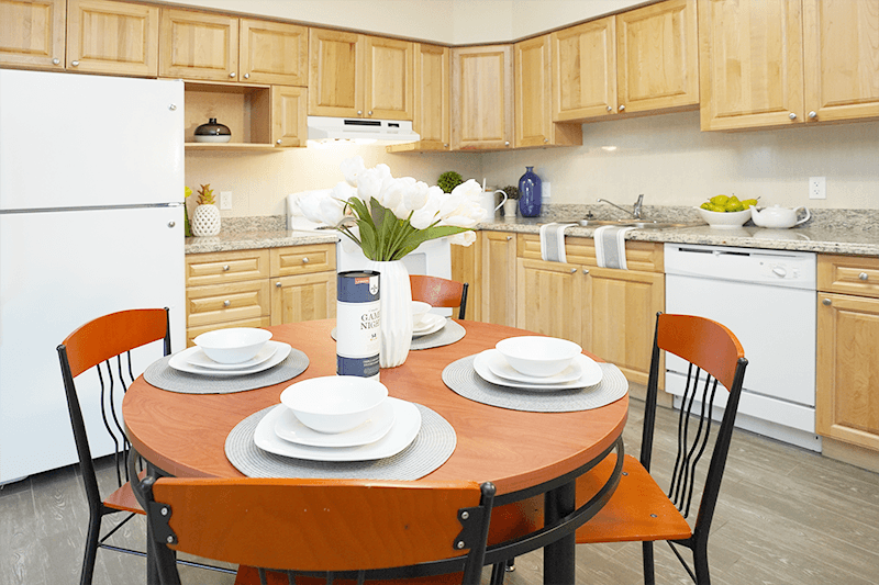 a kitchen and dining area with a table and chairs