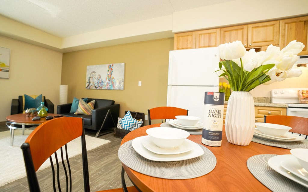 a dining room table with plates and a vase of flowers