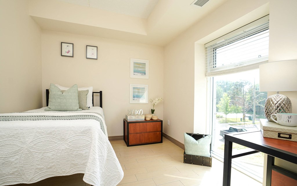 a bedroom with a bed and a window