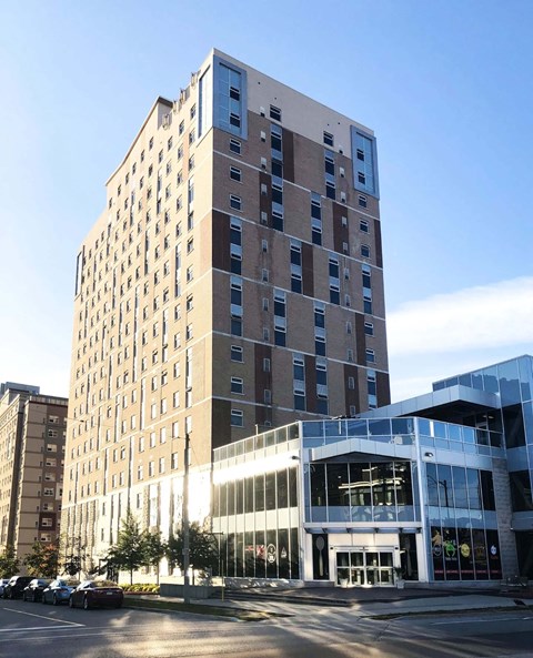 A tall building with a lot of windows is in the foreground.