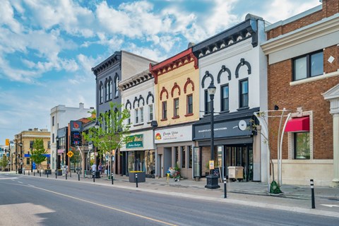 A street view of a small town with buildings on both sides.