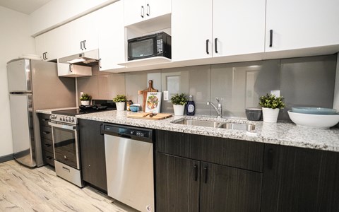a kitchen with stainless steel appliances and a granite counter top