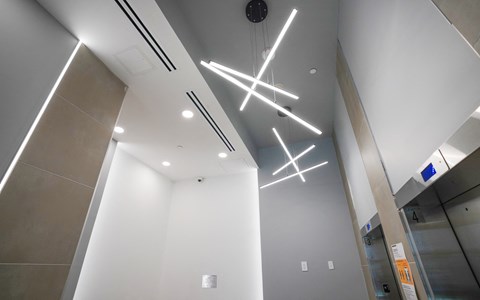 a view of the lobby of a building with lights on the ceiling