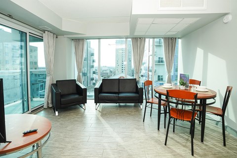 a living room and dining room with a table and chairs