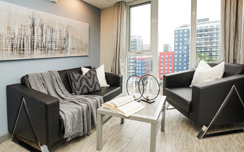 a living room with black and white furniture and a large window