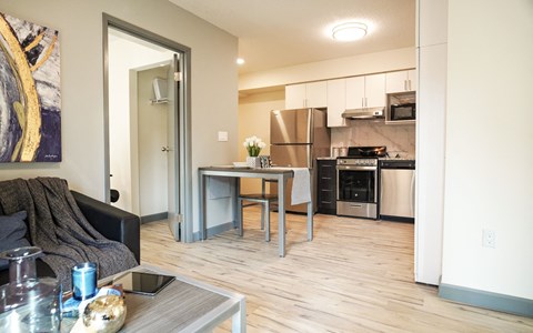 a living room with a kitchen and a dining room