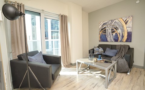 a living room with a black couch and a coffee table