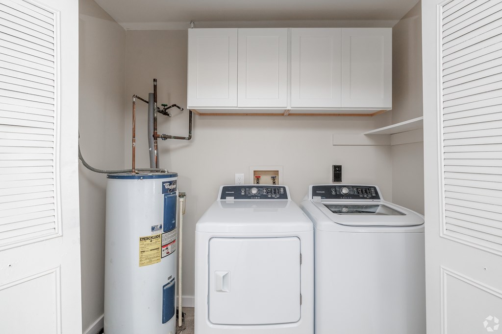 A small laundry room with a washer and dryer.