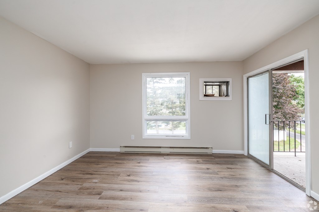 A room with a large window and a sliding glass door.