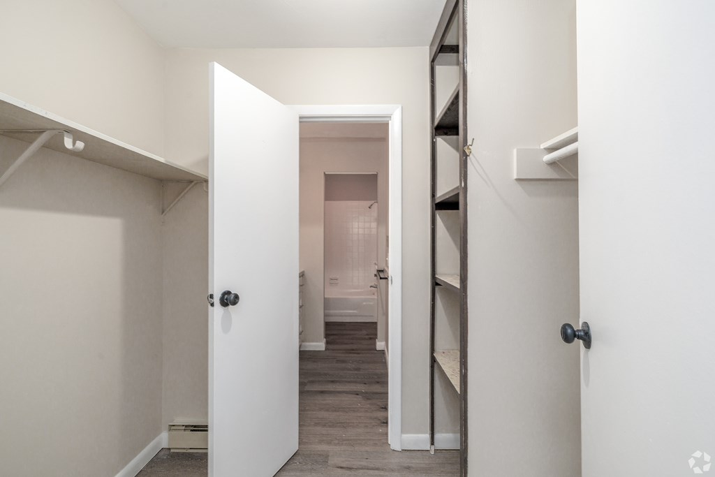 A white door is open to a hallway.