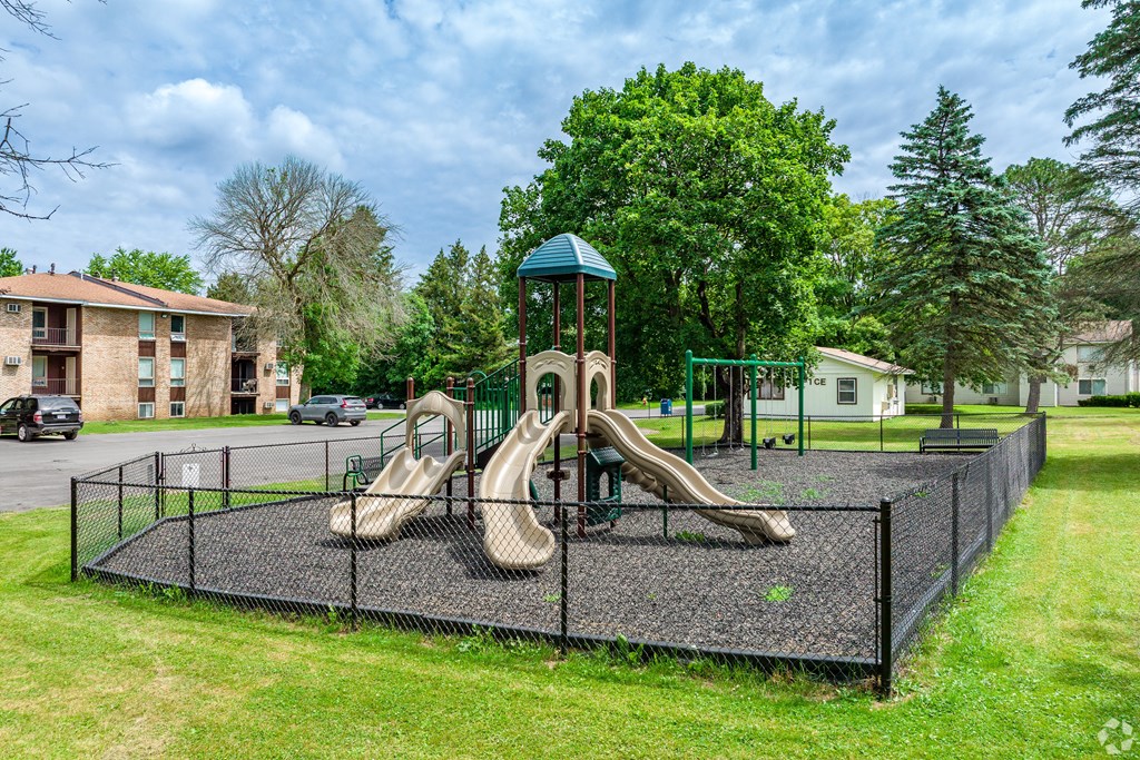 A playground with a slide and swings.