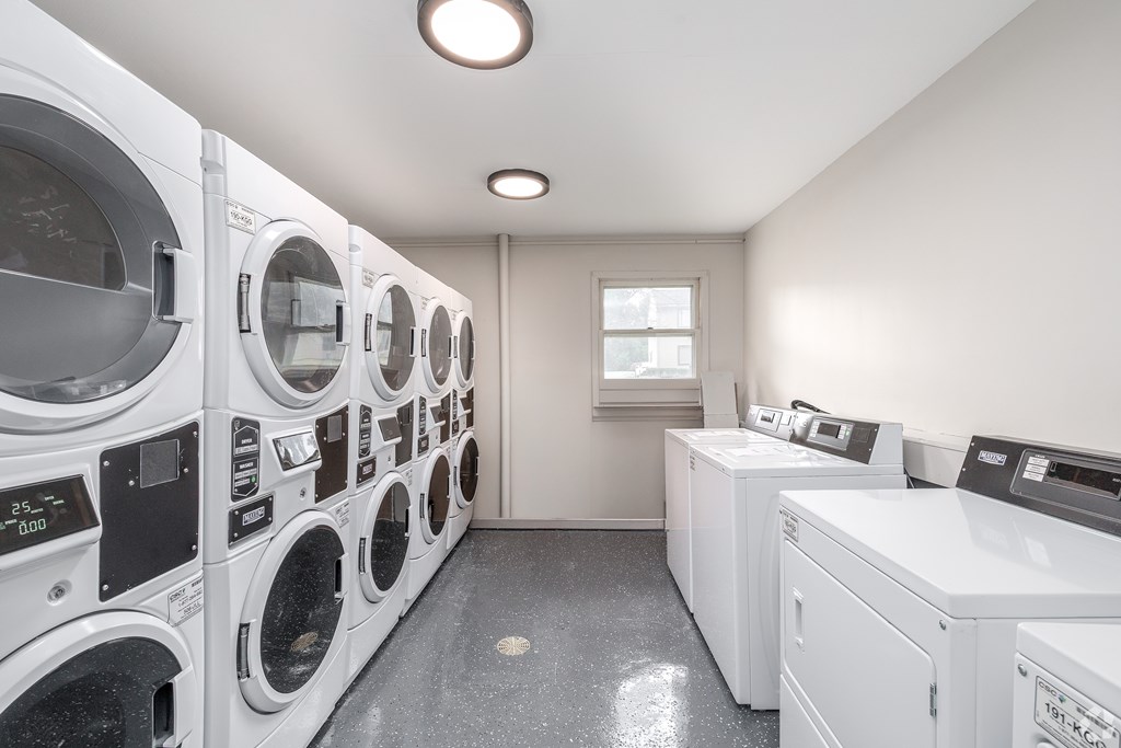 A row of washing machines in a laundromat.