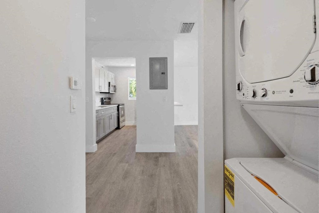 a white laundry room with a washer and dryer in it
