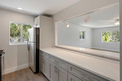 a kitchen with a counter top and a refrigerator