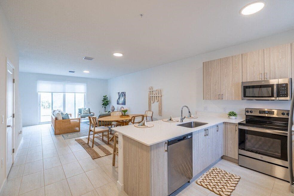A kitchen with an island and a living room