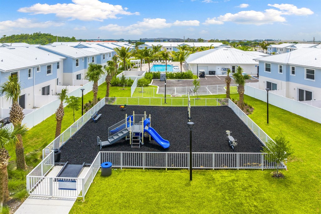 An aerial view of a playground and a pool in an apartment complex