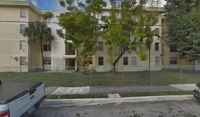 a view of an apartment building from behind a fence
