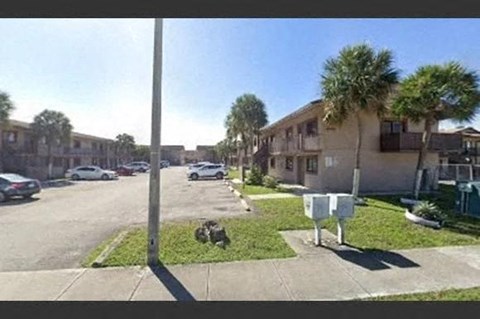 a street with cars parked in front of houses