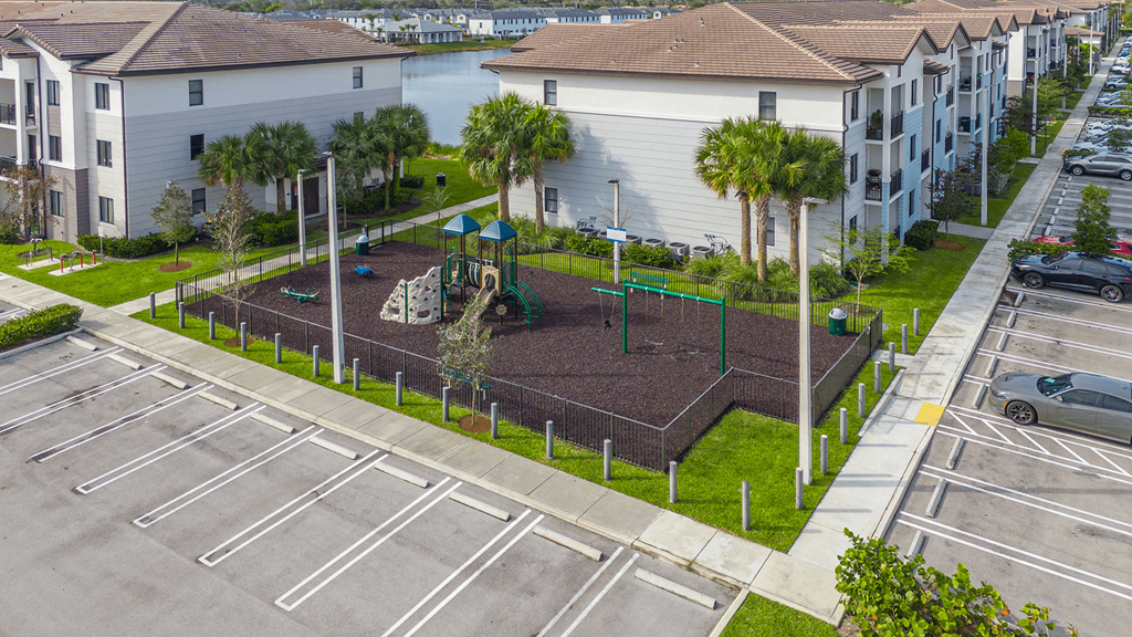 an aerial view of a park in the middle of a parking lot