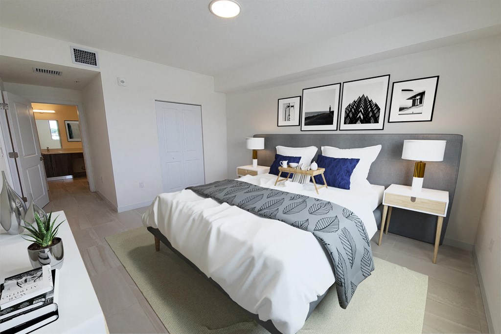 a bedroom with a white bed and a bathroom