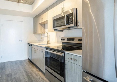 a kitchen with stainless steel appliances and white cabinets