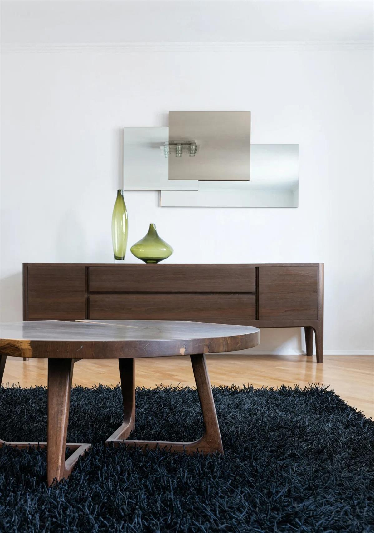 a wooden table with a green vase on top of it
