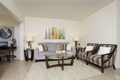 A living room with a couch, chair, and coffee table.