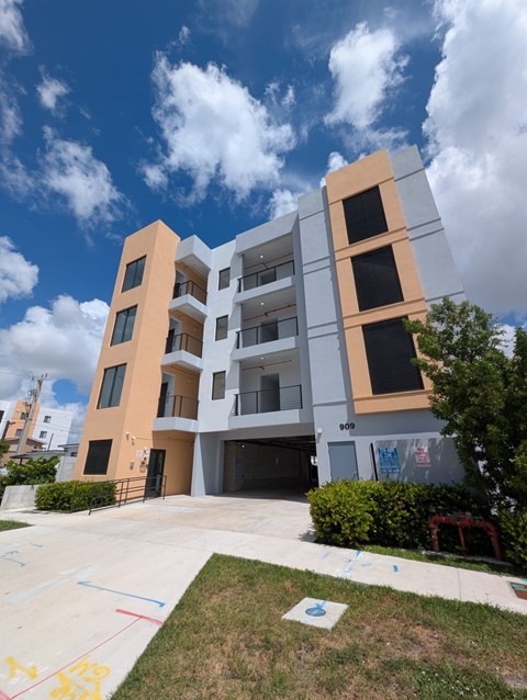 A modern apartment building with a playground in front.