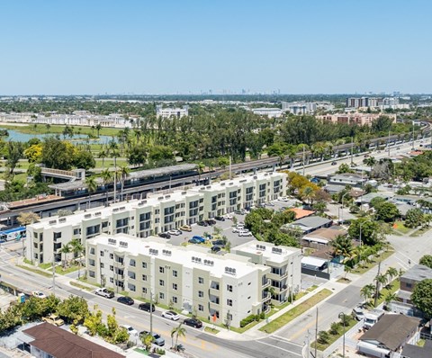 A large white building with a parking lot in front of it.