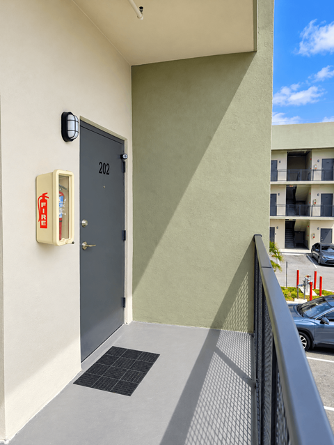 A grey door with the number 202 on it.