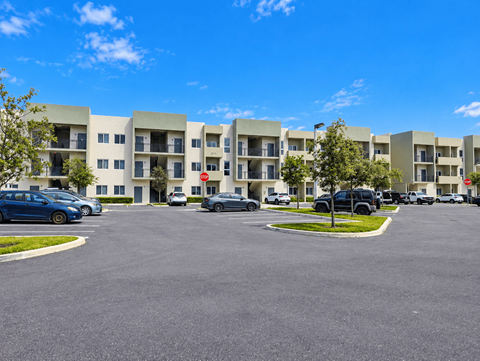 A parking lot in front of apartment buildings.