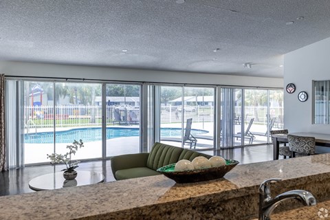 A kitchen with a marble countertop and a bowl of fruit on it.