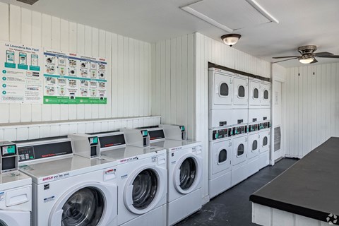 A row of washing machines in a laundromat.