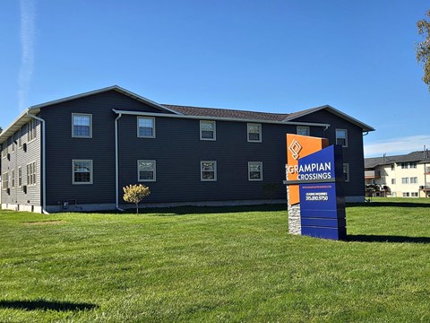 A large building with a sign that says "GRAMPIAN CROSSINGS" in front of it.