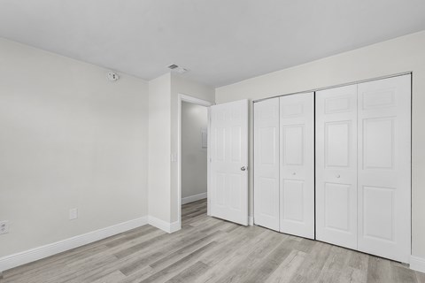A room with a white door and a white wall.