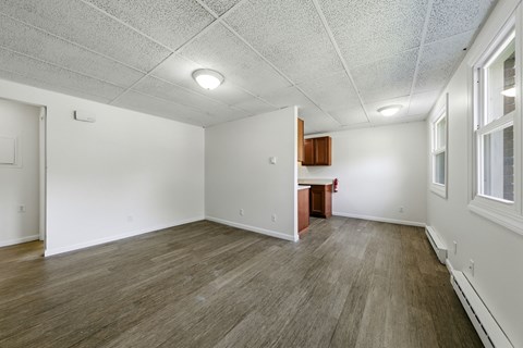A room with wooden flooring and white walls.