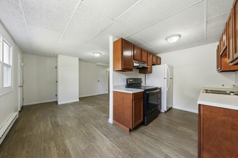 A kitchen with a refrigerator, oven, and microwave.