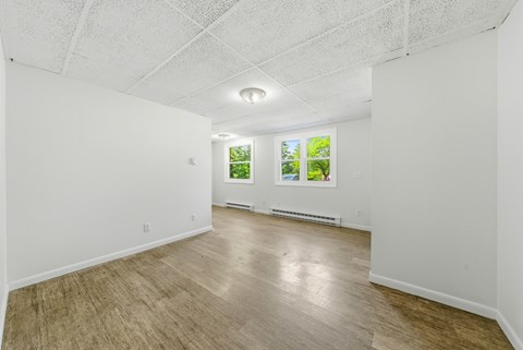 A room with white walls and wooden flooring.