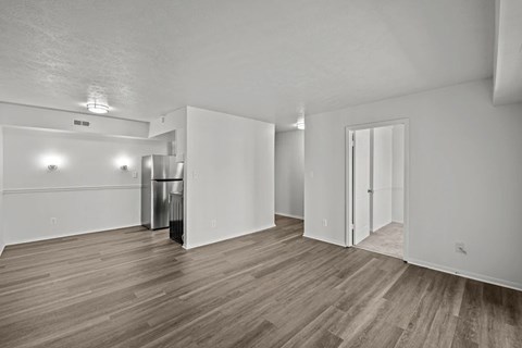 A room with wood flooring and white walls.