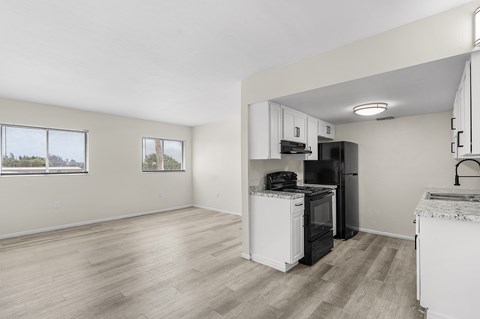 A kitchen with white appliances and cabinets.