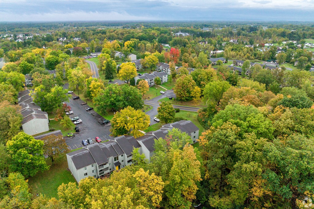 A view of a residential area with houses and trees.