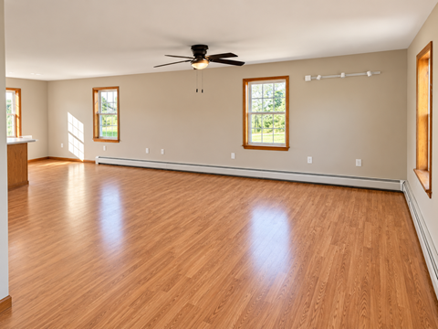 A room with wooden floors and a ceiling fan.