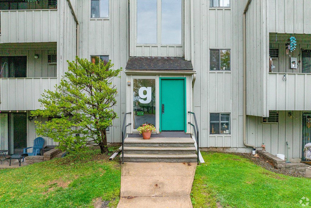 A green door is on the side of a building.