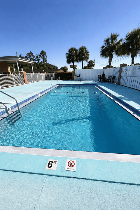 A swimming pool with a 6ft depth sign and no diving sign.