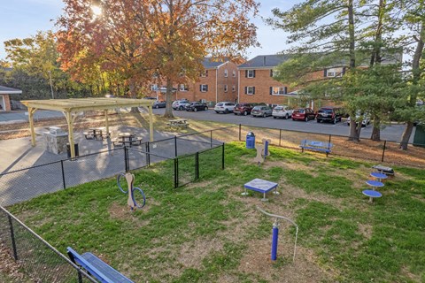 A playground with a swing set and a blue slide.