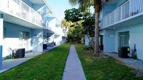 A long white balcony runs along the side of a building.