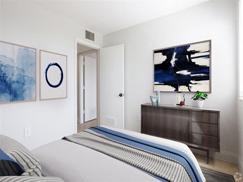 a bedroom with a bed and a dresser